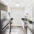 Galley  kitchen with white cabinets and black appliances