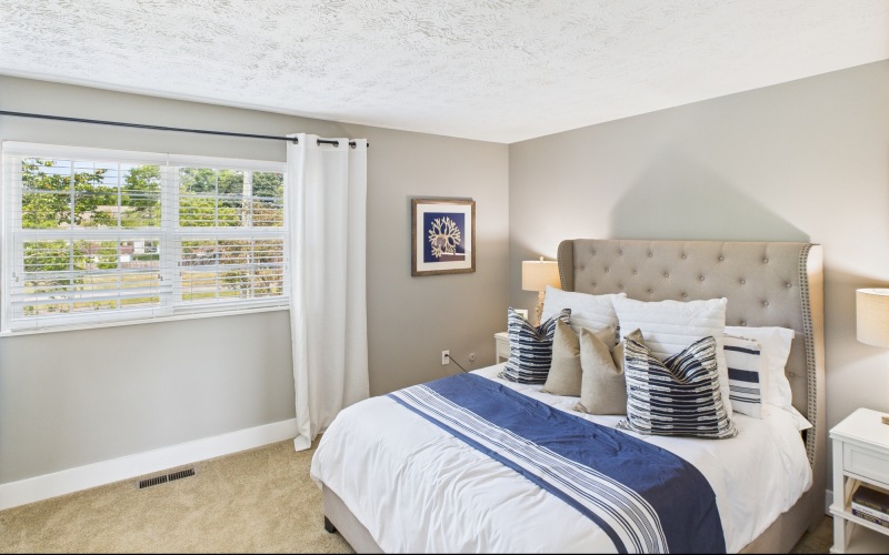 Styled apartment bedroom with blue accents