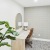 Room with desk, art, and plant