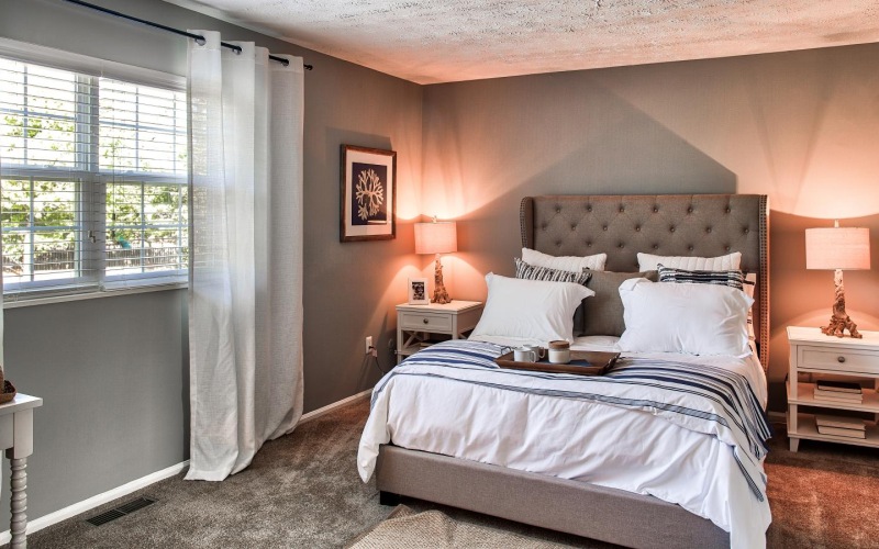 a bedroom with a bed and a window